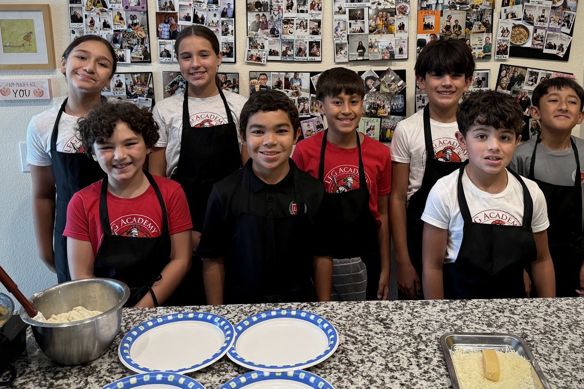 LFG Academy students in aprons at the end of a cooking class