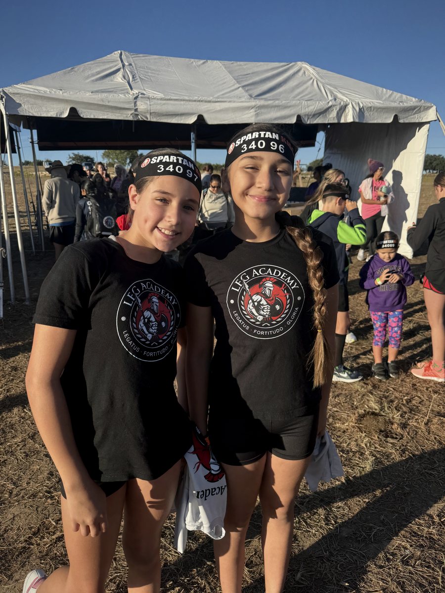 Two LFG Academy students in team shirts before a Spartan race